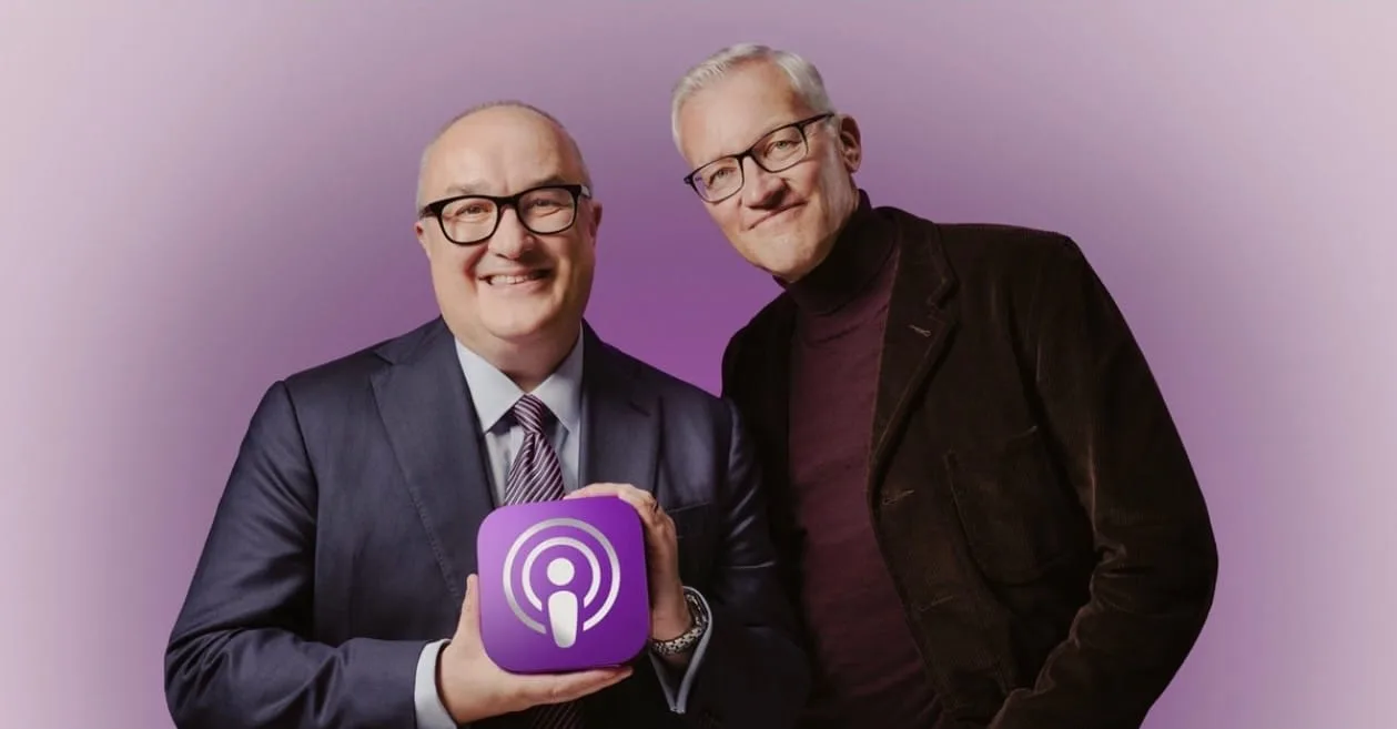 The hosts of The Rest Is History holding the Apple Podcasts logo